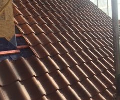 An image of a newly tiled roof we did