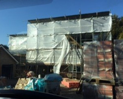 An Image of a house that is being renovated using scaffolding