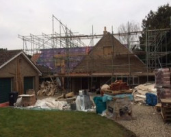 An Image of a house that is being renovated using scaffolding